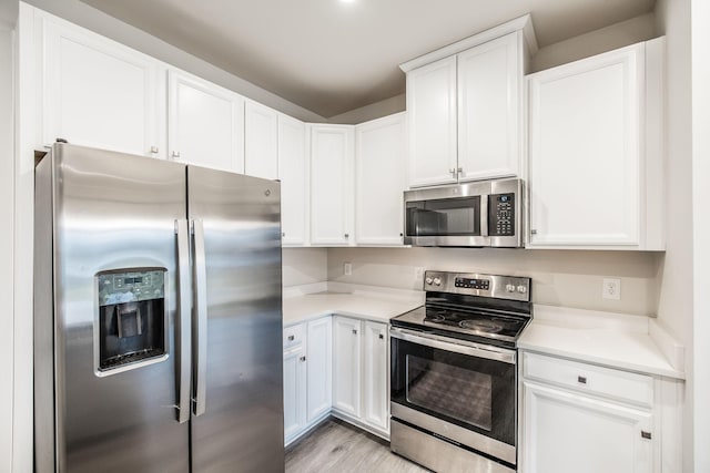 1335 Crescent Ridge Dr, Gallatin, TN 37066 - kitchen featuring stainless steel appliances, light wood-type flooring, and white cabinets