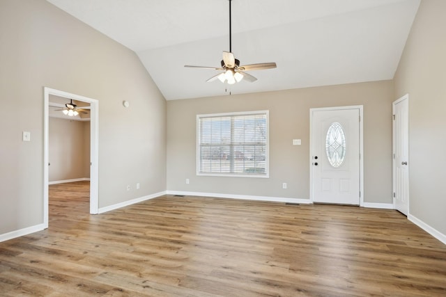 entrance foyer featuring ceiling fan, lofted ceiling, and light wood-type flooring