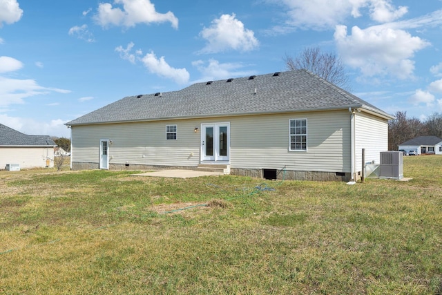 rear view of house featuring a lawn, a patio, and french doors