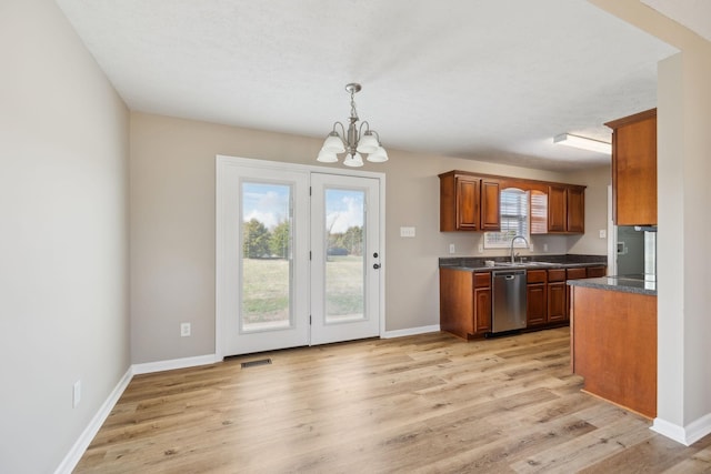 kitchen featuring decorative light fixtures, stainless steel dishwasher, an inviting chandelier, and light hardwood / wood-style flooring