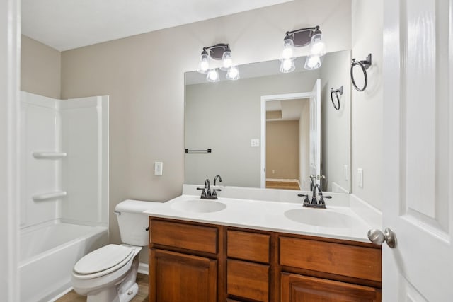 full bathroom featuring washtub / shower combination, vanity, and toilet