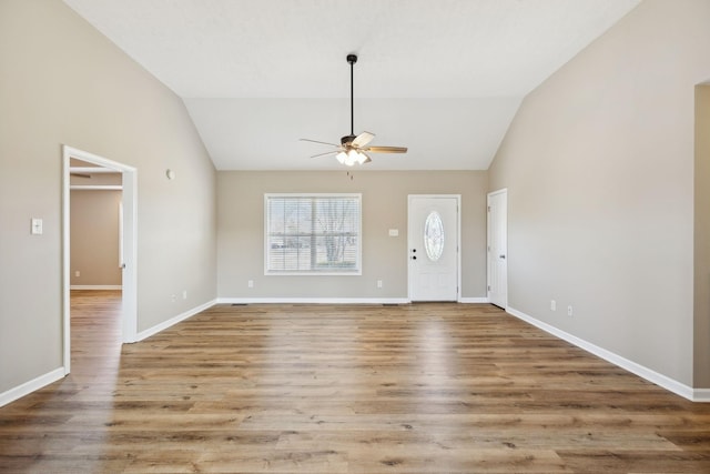 foyer with hardwood / wood-style floors, vaulted ceiling, and ceiling fan