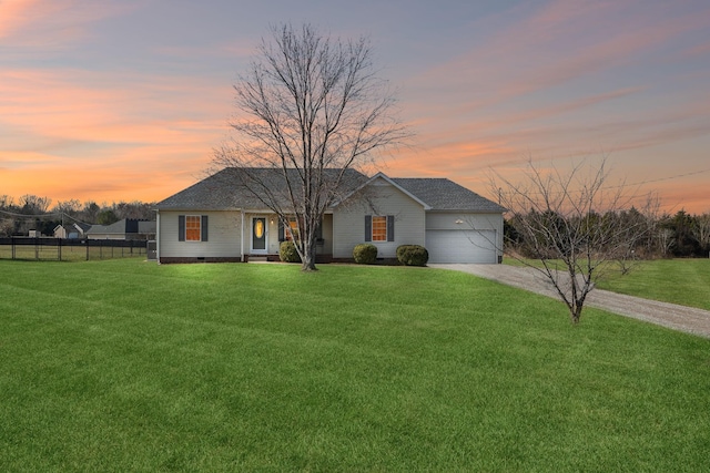 view of front facade featuring a garage and a lawn