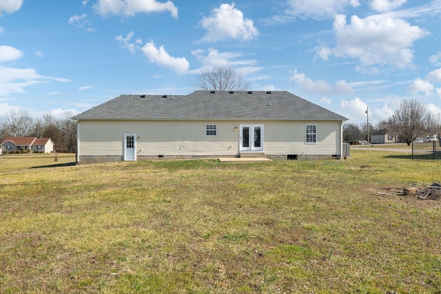 rear view of property with a lawn