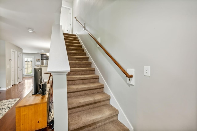 stairs with hardwood / wood-style flooring