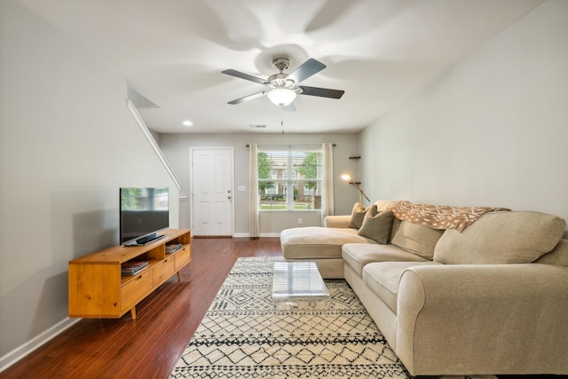 living room featuring dark hardwood / wood-style flooring and ceiling fan