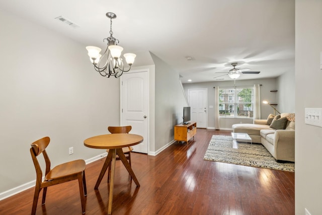 dining area with dark hardwood / wood-style floors and ceiling fan with notable chandelier