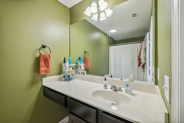 bathroom featuring vanity, a notable chandelier, a shower with curtain, and toilet