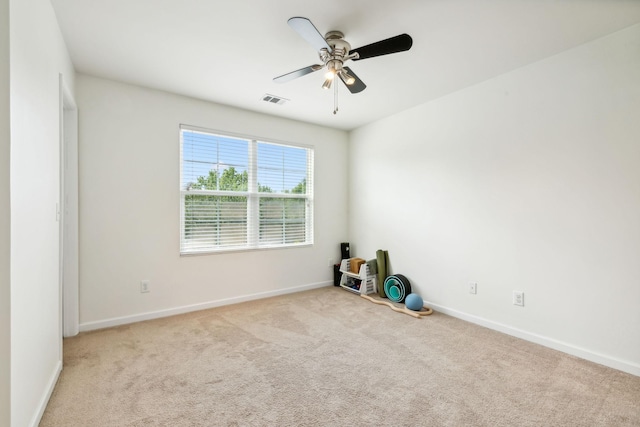 unfurnished room with ceiling fan and light carpet