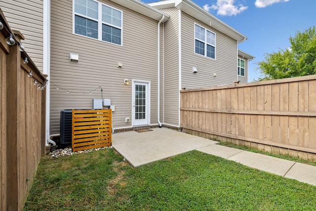 back of house featuring a patio and a lawn