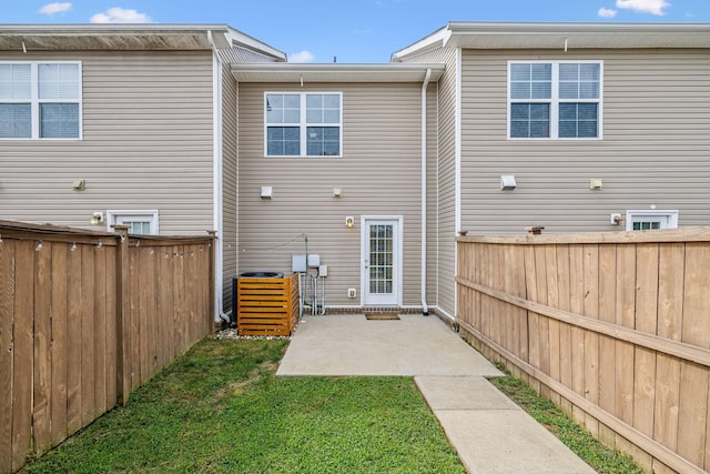 rear view of house with a patio area and a lawn