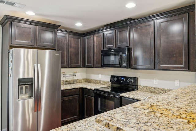 kitchen with dark brown cabinets, light stone counters, and black appliances