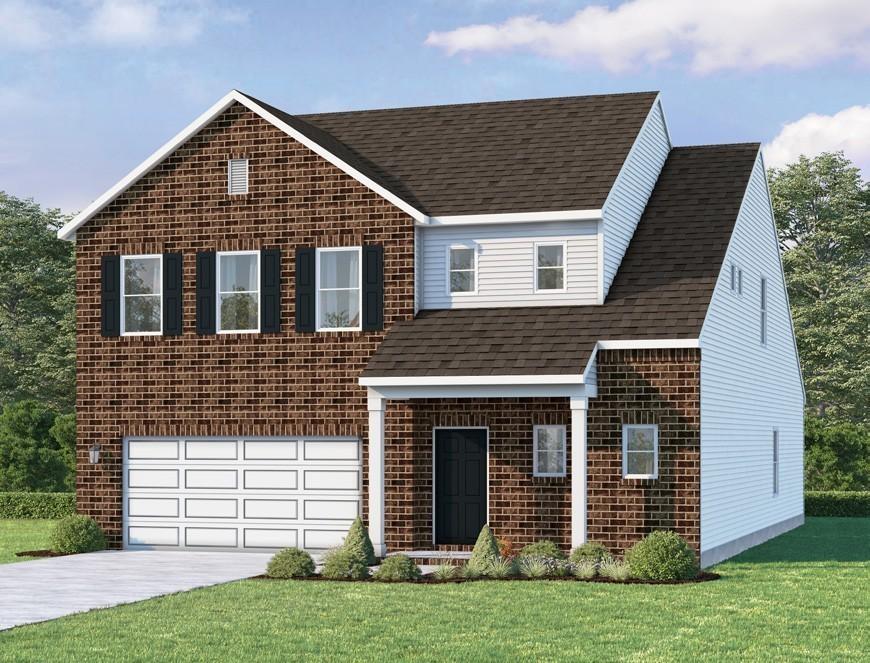 view of front of home featuring a front yard and a garage