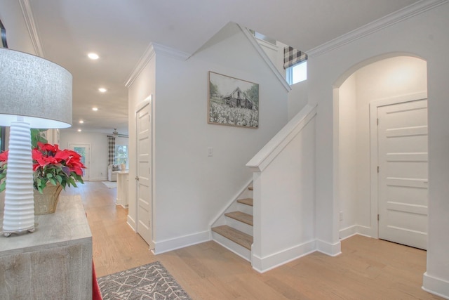 entrance foyer with hardwood / wood-style flooring and crown molding