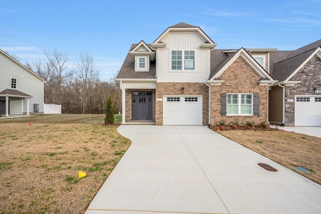 craftsman inspired home featuring driveway, brick siding, board and batten siding, and a front yard