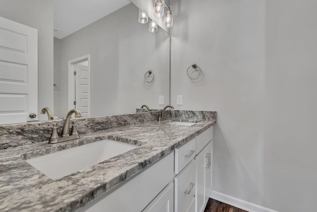 bathroom with vanity and wood-type flooring