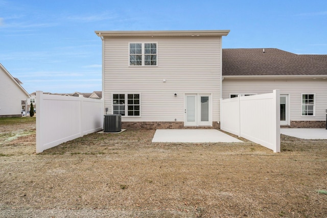 rear view of property featuring central AC, a yard, a patio, and fence