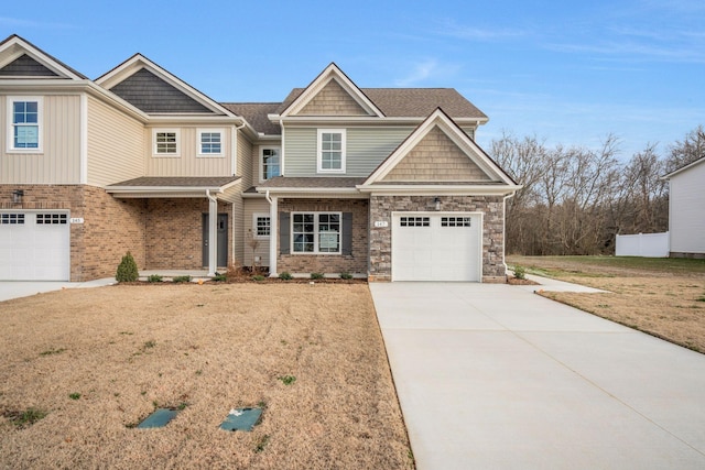 view of front of property featuring a garage, a shingled roof, driveway, stone siding, and a front lawn