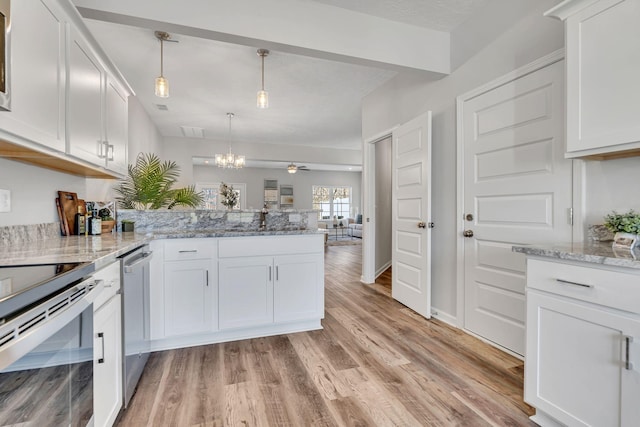 kitchen with pendant lighting, a peninsula, light stone counters, and white cabinets