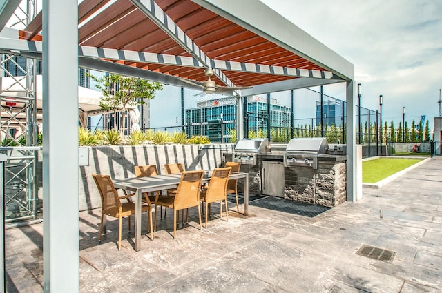 515 Church St Unit 3208, Nashville, TN 37219 - view of patio / terrace with area for grilling, a bar, ceiling fan, and exterior kitchen