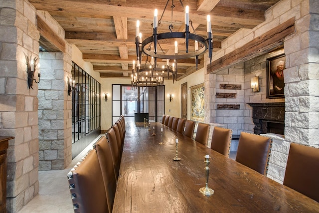 515 Church St Unit 3208, Nashville, TN 37219 - unfurnished dining area featuring an inviting chandelier, a stone fireplace, wooden ceiling, and beamed ceiling