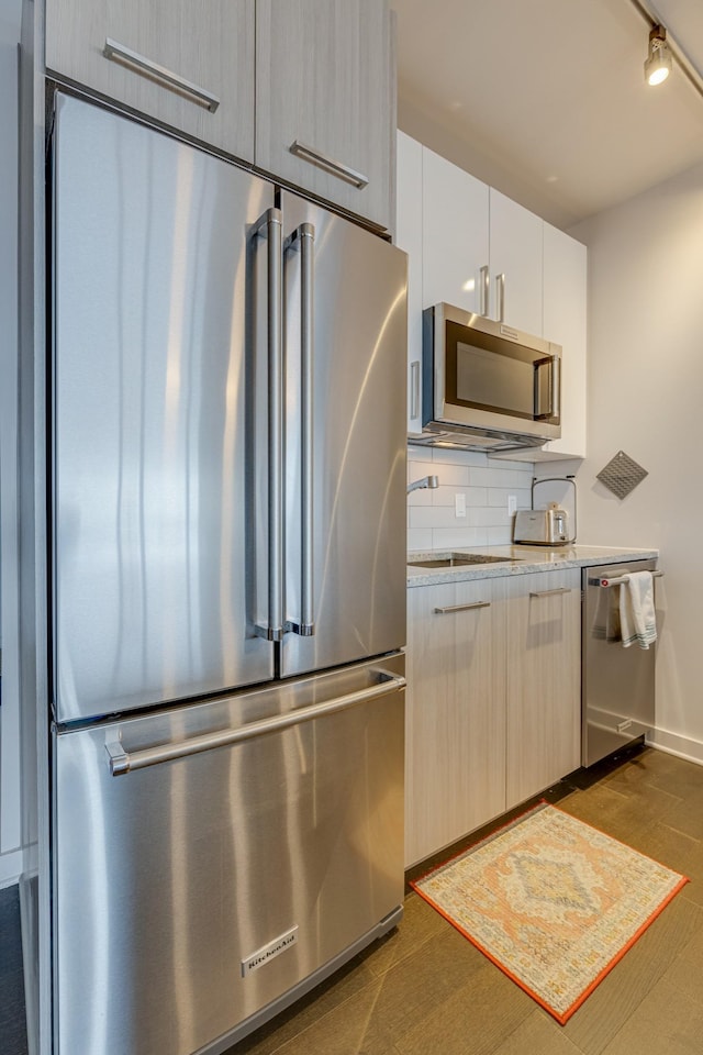 515 Church St Unit 3208, Nashville, TN 37219 - kitchen featuring sink, white cabinetry, stainless steel appliances, dark hardwood / wood-style flooring, and decorative backsplash
