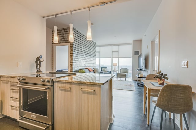 515 Church St Unit 3208, Nashville, TN 37219 - kitchen with dark wood-type flooring, stainless steel range with electric cooktop, pendant lighting, light brown cabinets, and expansive windows