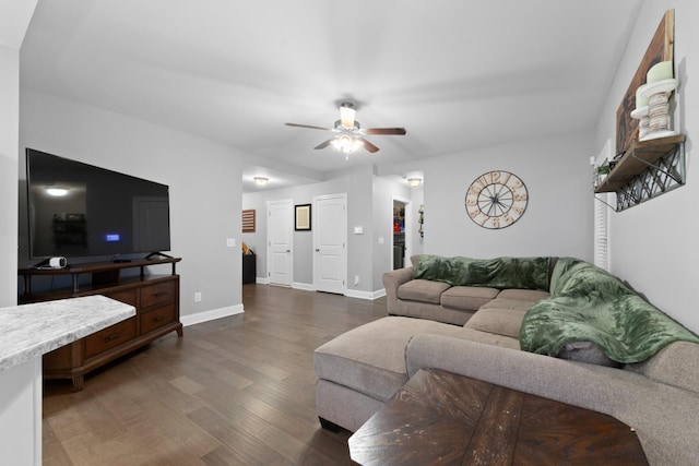 living room with dark wood-type flooring and ceiling fan