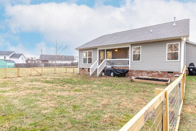 back of property with a porch and a yard