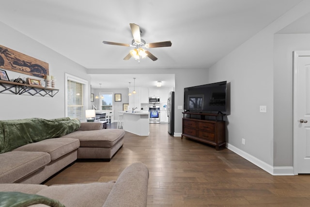 living room featuring dark hardwood / wood-style floors and ceiling fan