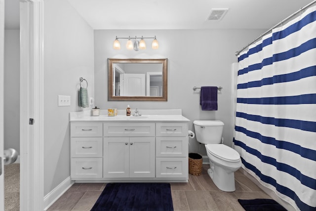 bathroom featuring vanity, toilet, and a shower with shower curtain