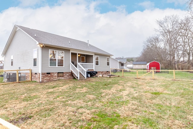 back of property featuring a yard and central AC unit