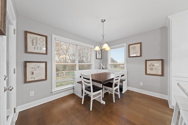 dining space featuring an inviting chandelier and dark hardwood / wood-style floors