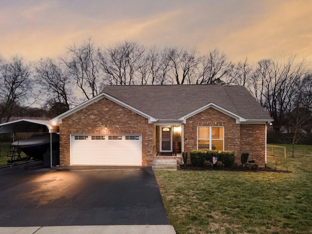 view of front facade featuring a carport, a garage, and a yard