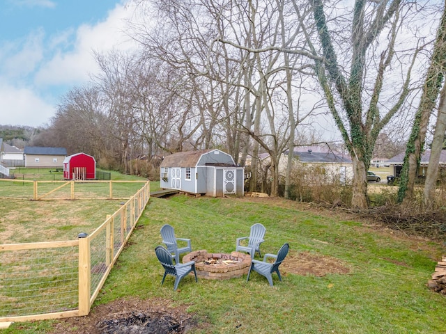 view of yard featuring a fire pit and a storage unit