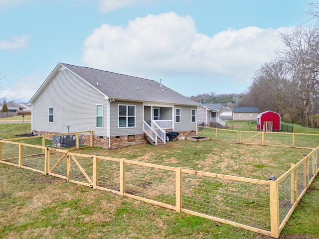 back of house with a lawn