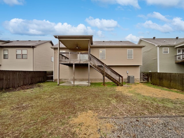 rear view of house with a deck, a lawn, ceiling fan, central air condition unit, and a patio area