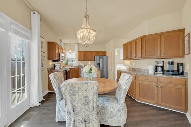 dining space with dark wood-type flooring and a notable chandelier