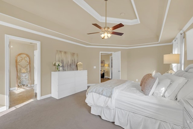 carpeted bedroom featuring crown molding, ceiling fan, and a tray ceiling