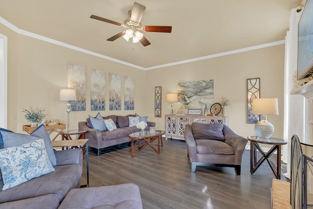 living room featuring dark hardwood / wood-style flooring, crown molding, a fireplace, and ceiling fan