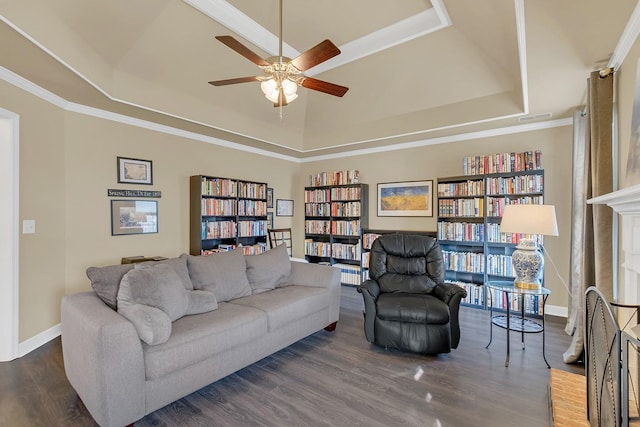 living room with ceiling fan, a fireplace, dark hardwood / wood-style flooring, and a raised ceiling