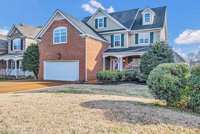 view of front of house featuring a garage and a front lawn