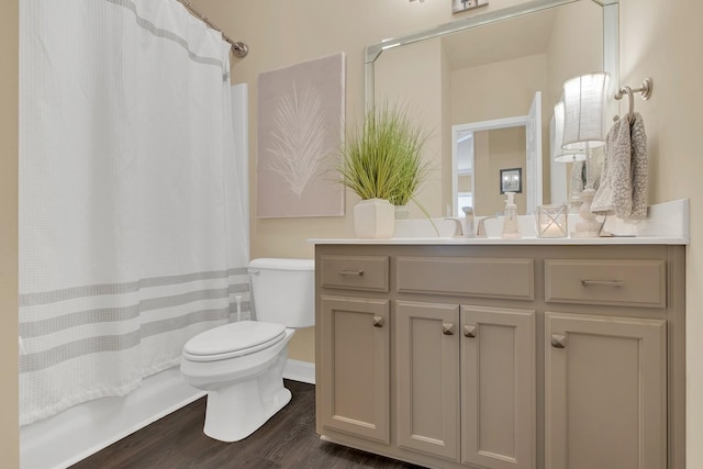 bathroom with vanity, toilet, and hardwood / wood-style floors