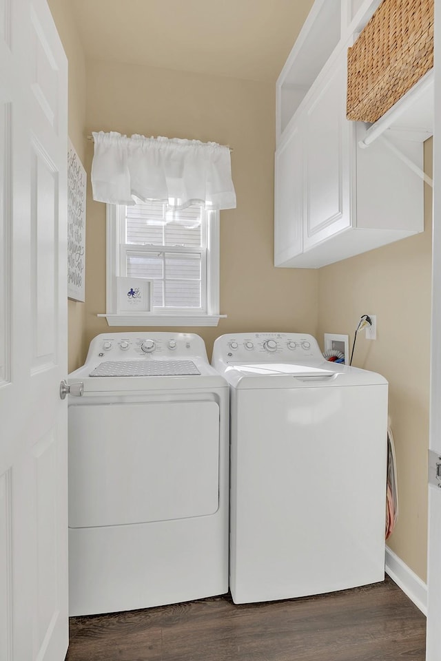 laundry area with cabinets, independent washer and dryer, and dark hardwood / wood-style floors