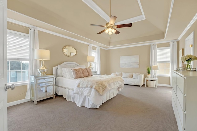 bedroom featuring a raised ceiling, crown molding, light colored carpet, and ceiling fan