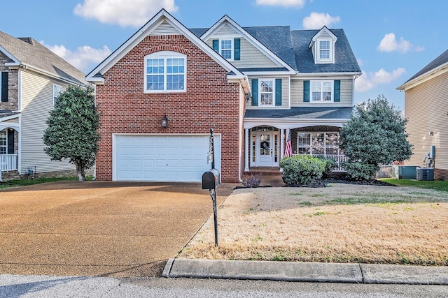 view of property with a garage and a porch