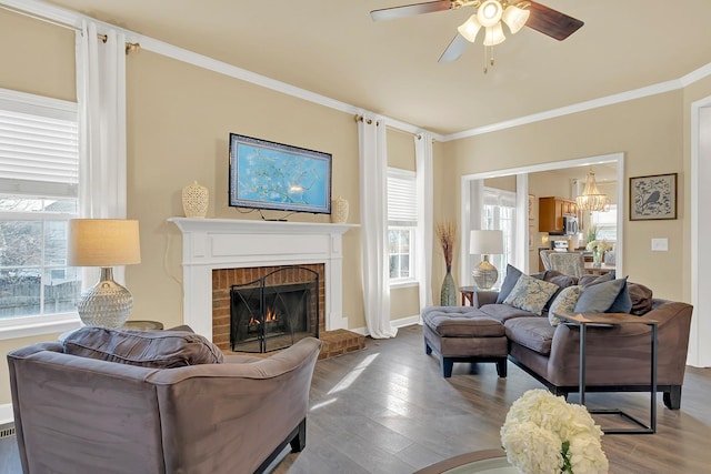 living room with ornamental molding, hardwood / wood-style floors, ceiling fan, and a fireplace