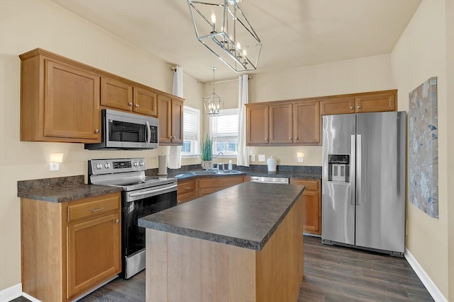 kitchen featuring sink, decorative light fixtures, a center island, dark hardwood / wood-style flooring, and stainless steel appliances