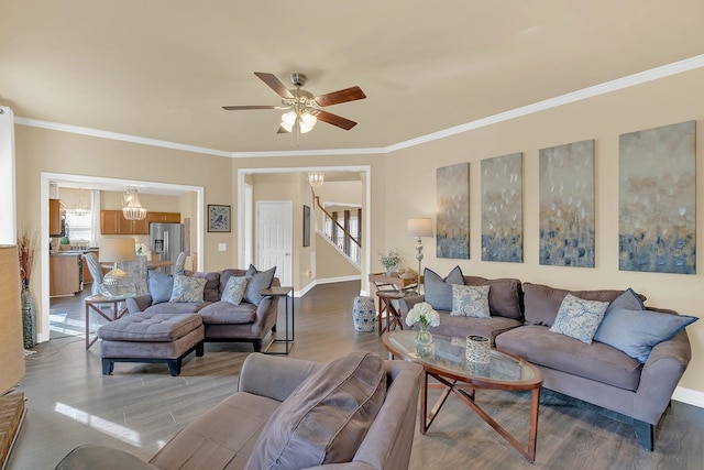 living room featuring hardwood / wood-style flooring, ceiling fan, and crown molding