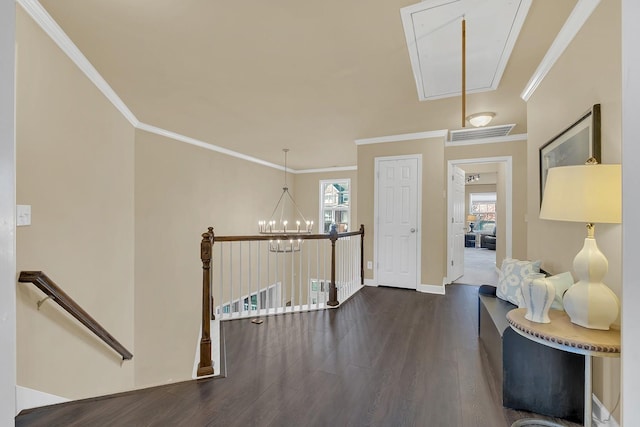 entryway with an inviting chandelier, crown molding, and dark hardwood / wood-style floors